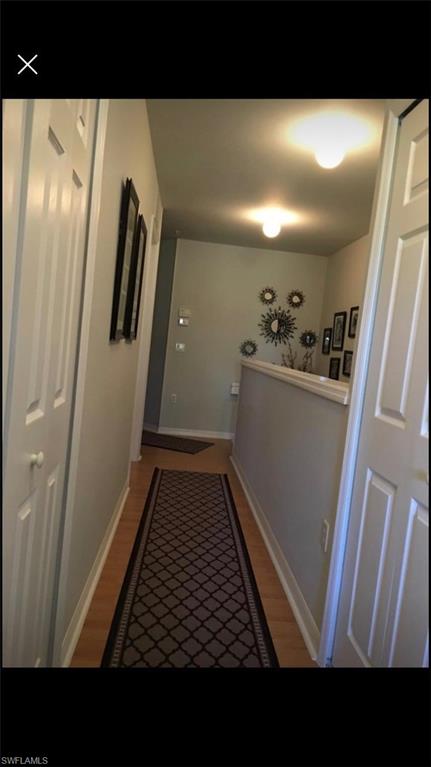 884 Hampton Circle, Unit 159 Naples, FL 34105 - Photo 10 of 28 a open area with wooden floor