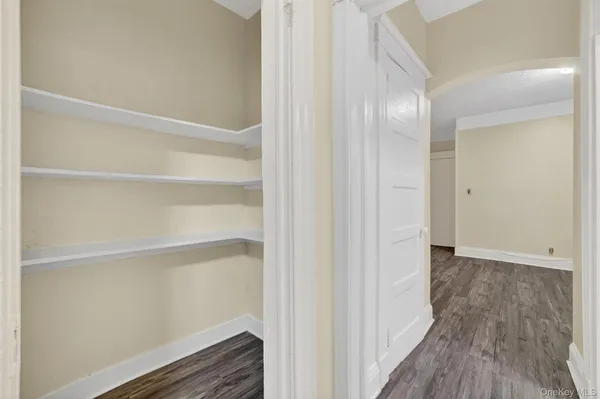 a view of closet area with wooden floor