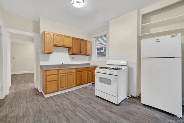a kitchen with a white cabinets and white appliances