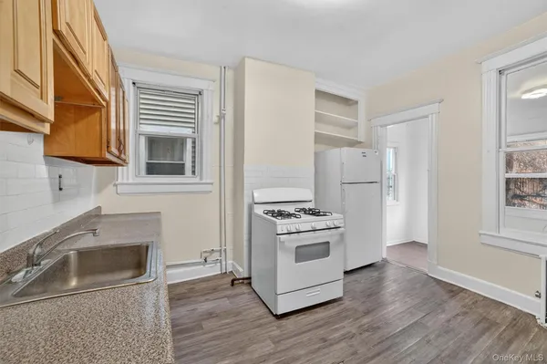 a kitchen with granite countertop a stove and a refrigerator