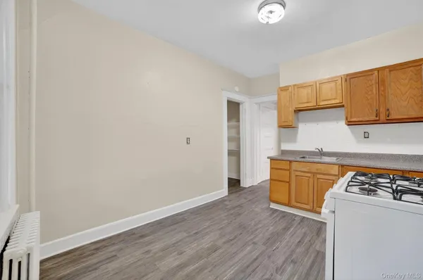 a kitchen with wooden floor and a stove top oven