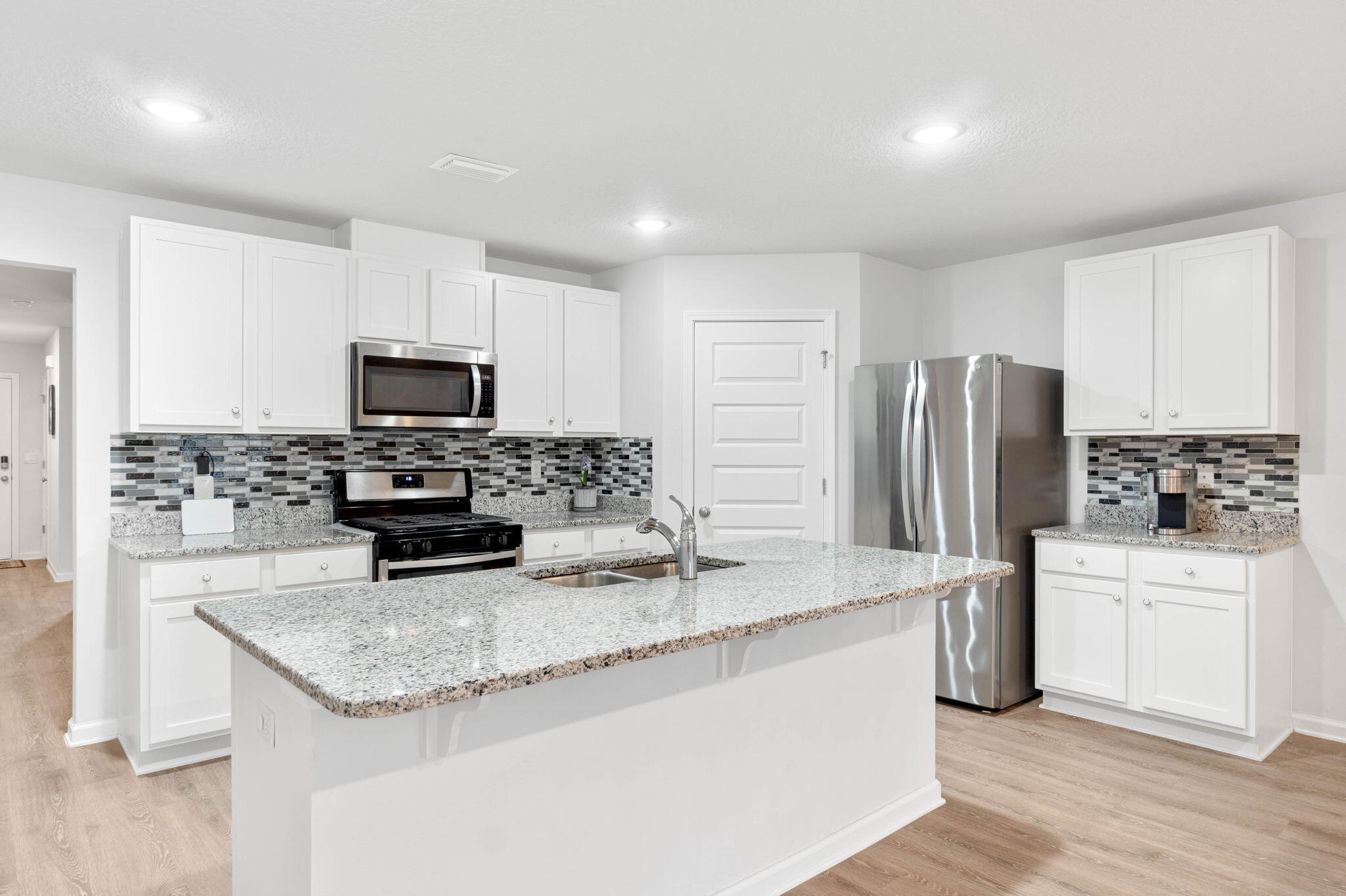 4614 Honor Guard Way Crestview, FL 32539 - Photo 12 of 48 a kitchen with refrigerator and microwave