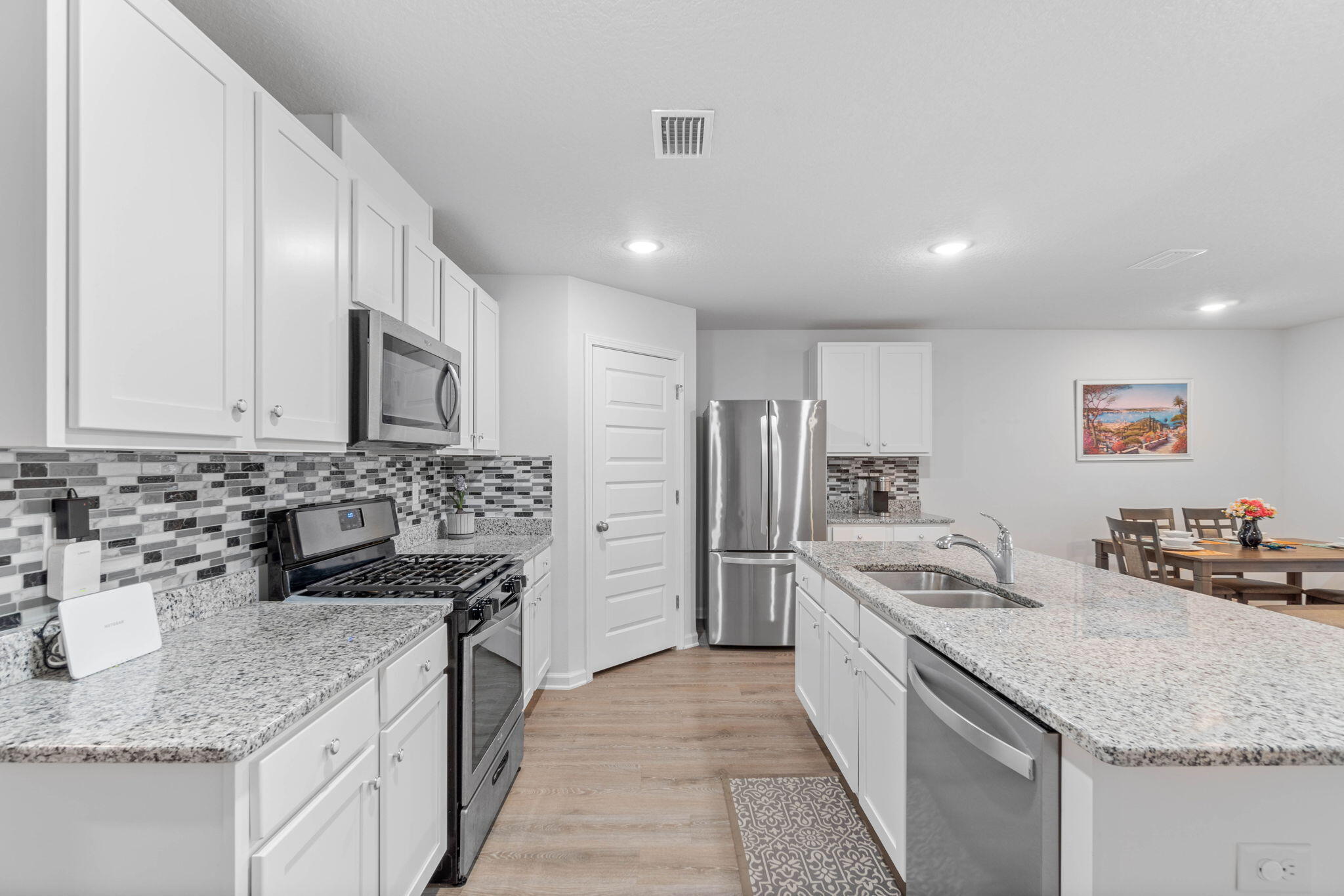 4614 Honor Guard Way Crestview, FL 32539 - Photo 13 of 48 a kitchen with stainless steel appliances granite countertop a sink stove and refrigerator