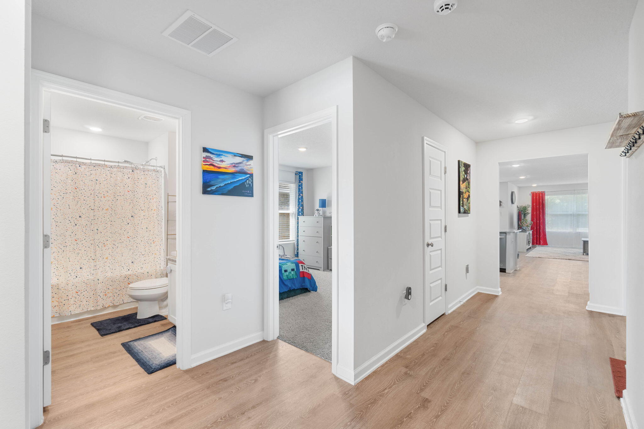 4614 Honor Guard Way Crestview, FL 32539 - Photo 7 of 48 a view of hallway with wooden floor and living room