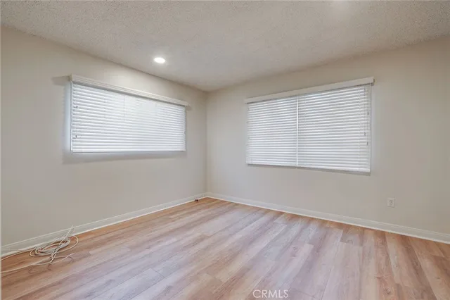 a view of a room with wooden floor and windows