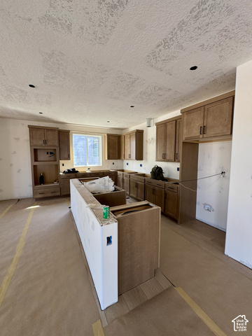 567 East Rimrock Lane Heber City, UT 84032 - Photo 3 of 16 Kitchen featuring wood-finish cabinetry, recessed lighting, and a center island with integrated cabinetry