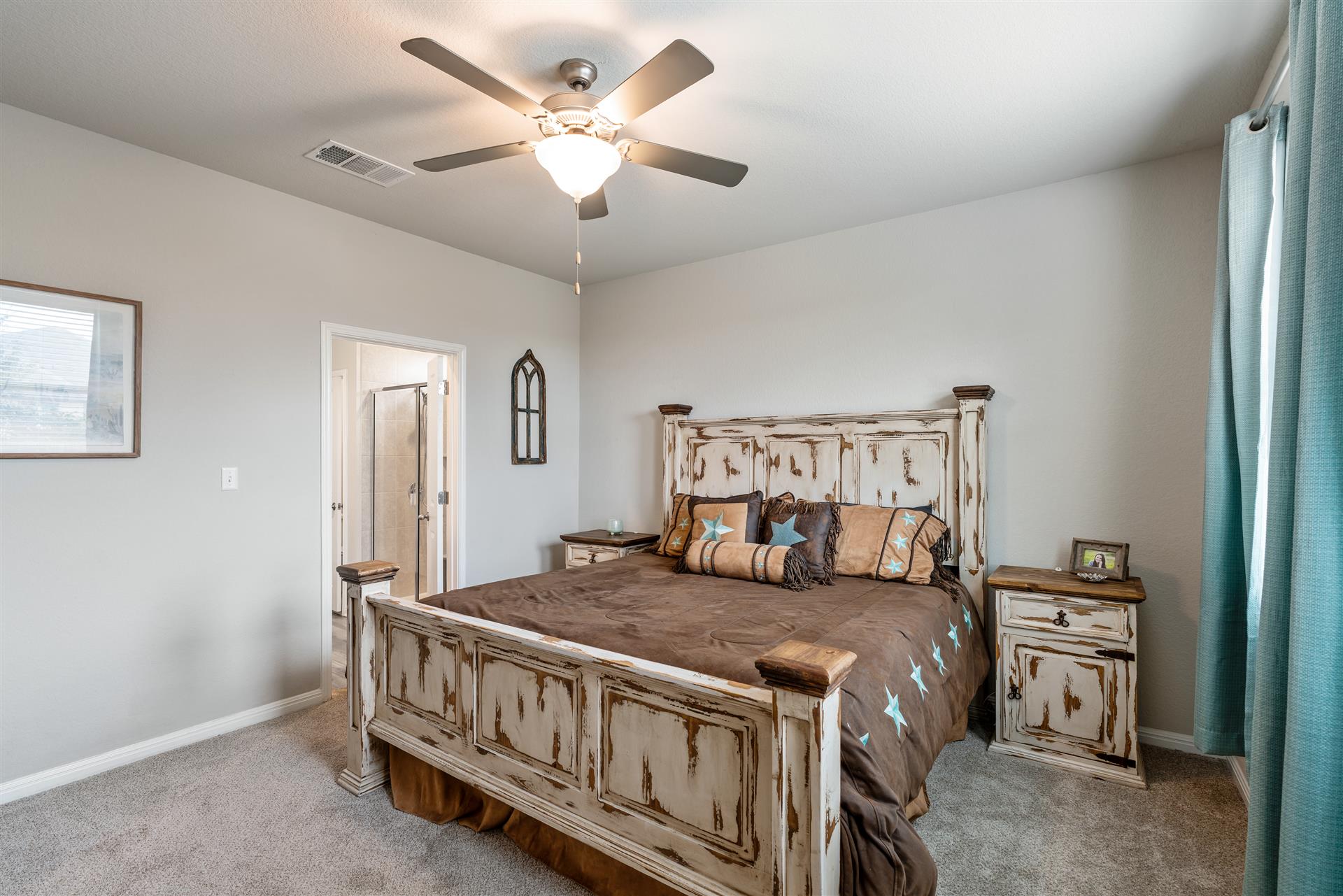 331 Mountain Valley Street Georgetown, TX 78628 - Photo 16 of 40 a bedroom with a bed a chandelier and a dresser