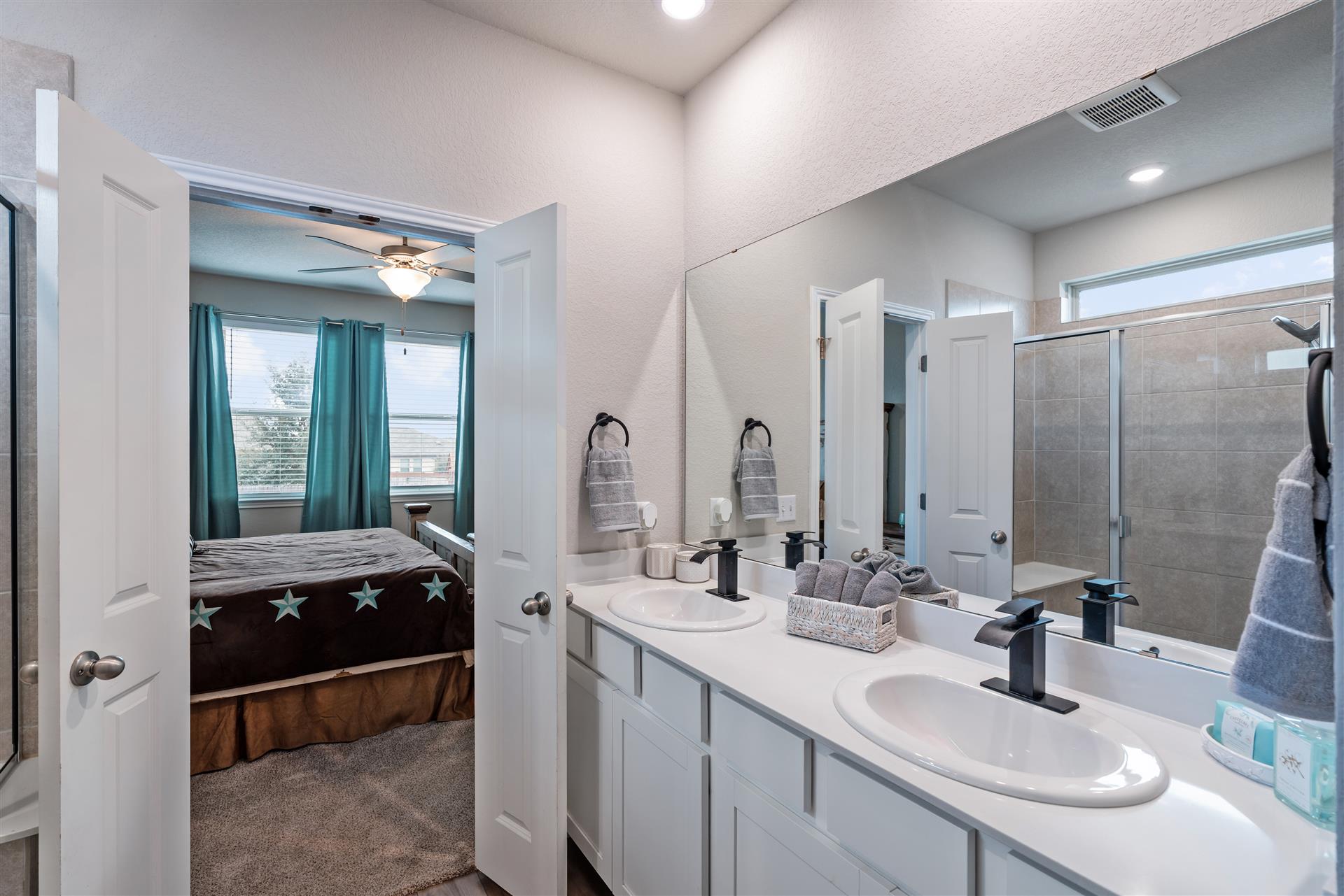 331 Mountain Valley Street Georgetown, TX 78628 - Photo 17 of 40 Ensuite bathroom with a shower w/ seat bench, double vanity