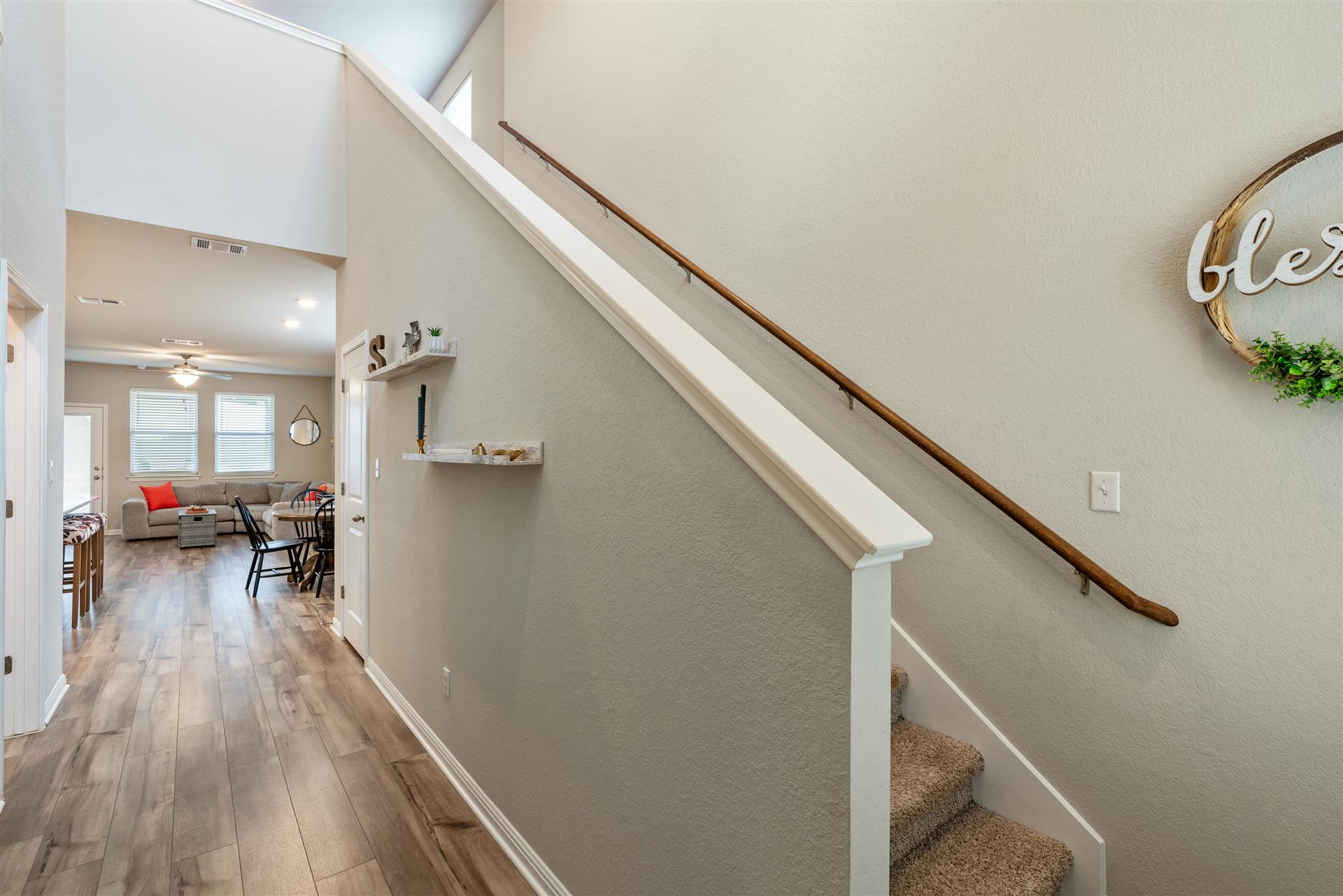 331 Mountain Valley Street Georgetown, TX 78628 - Photo 19 of 40 Entry Hall with wood-type flooring, a high ceiling, healthy amount of natural light, and a textured wall