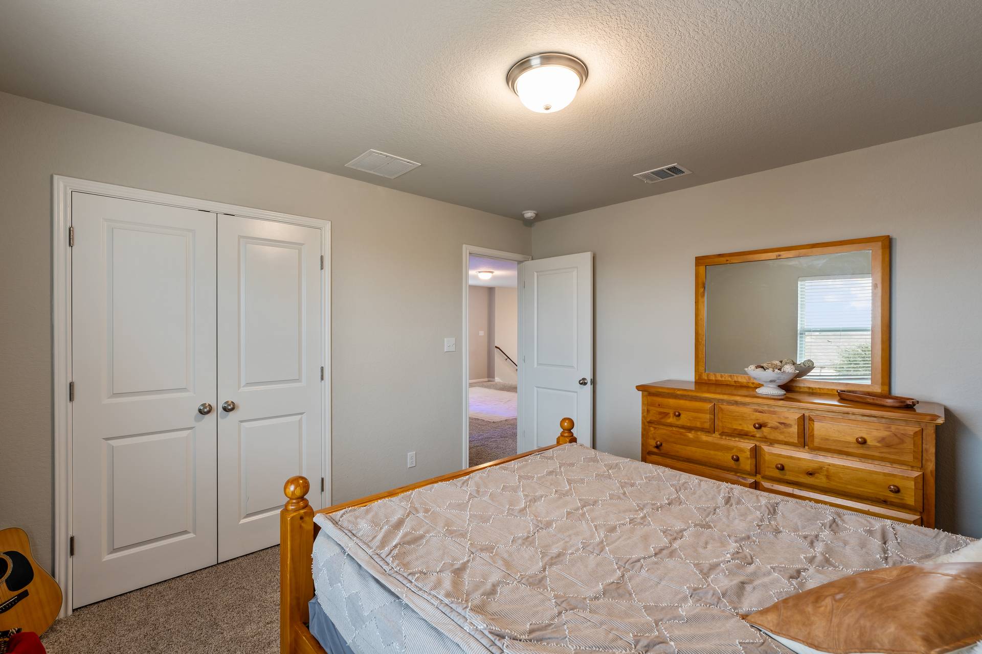 331 Mountain Valley Street Georgetown, TX 78628 - Photo 25 of 40 Bedroom 2 featuring a closet and a textured ceiling