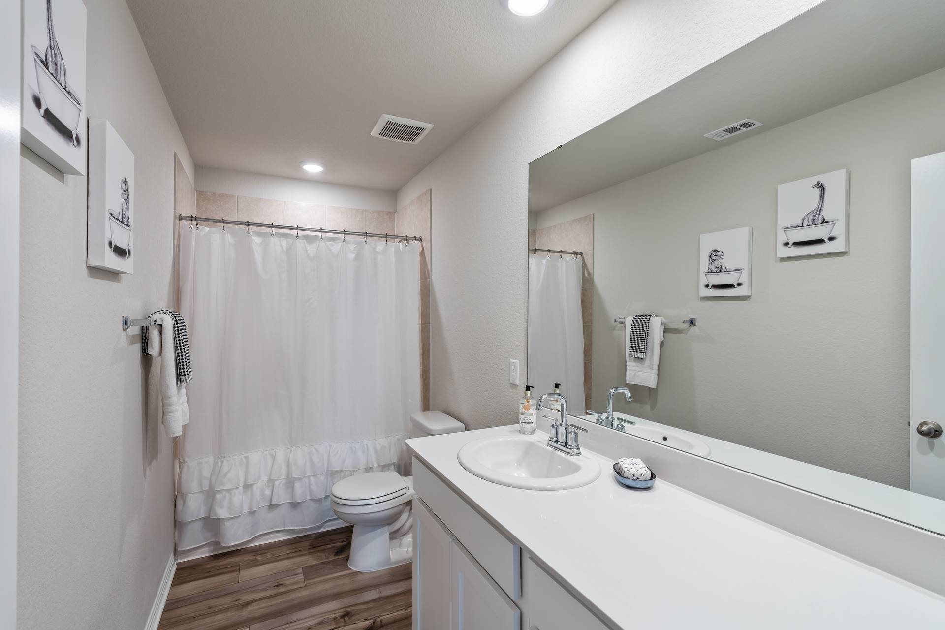 331 Mountain Valley Street Georgetown, TX 78628 - Photo 28 of 40 Upstairs bathroom featuring shower / tub combo with curtain, vanity, wood-type flooring, and recessed lighting
