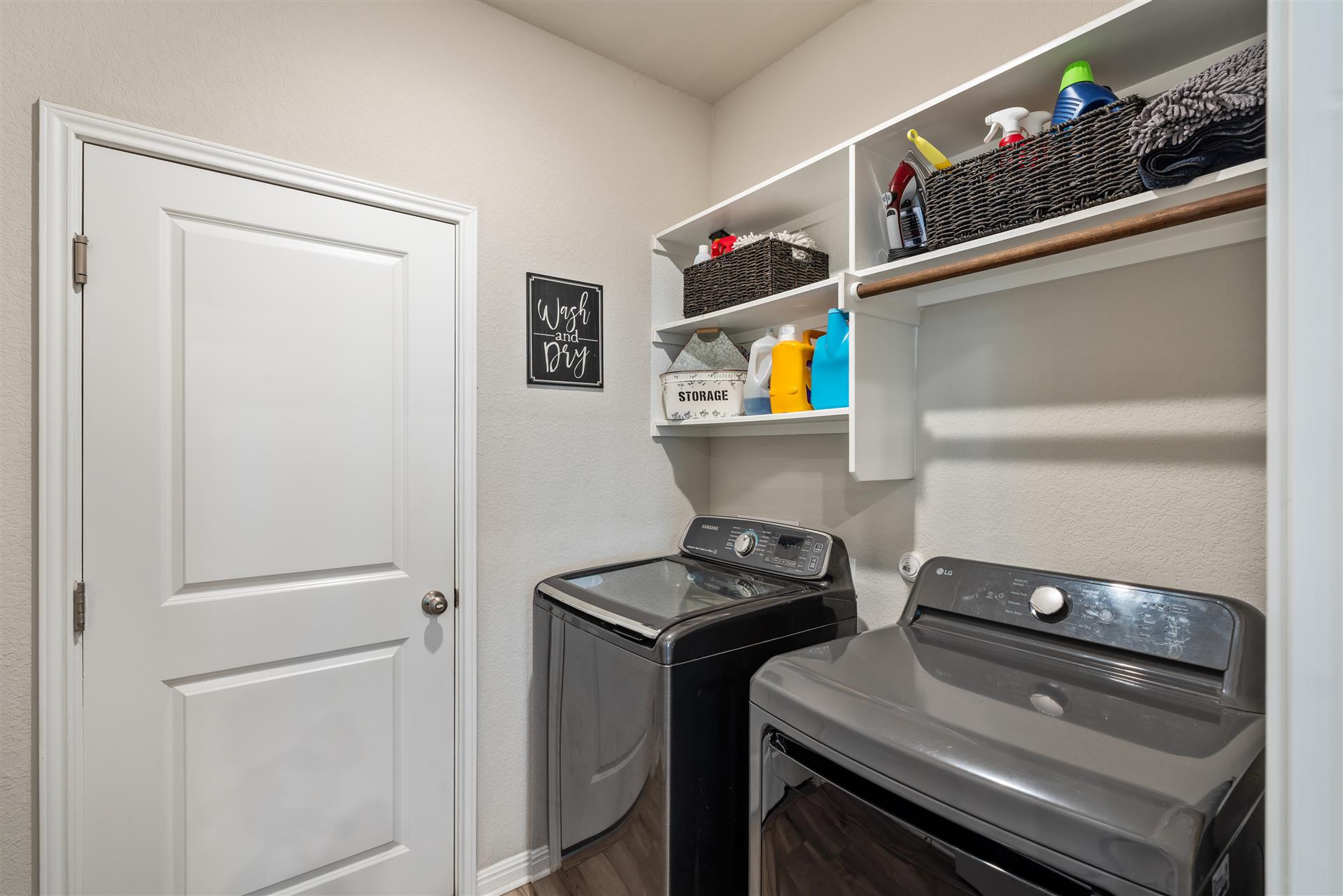 331 Mountain Valley Street Georgetown, TX 78628 - Photo 30 of 40 Laundry area located downstairs with shelving, access to the garage area