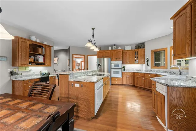 a large kitchen with kitchen island a sink counter space and stainless steel appliances