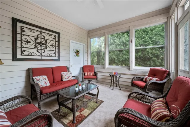 a living room with furniture and a large window
