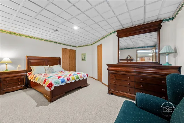 a bedroom with a bed dresser and a window