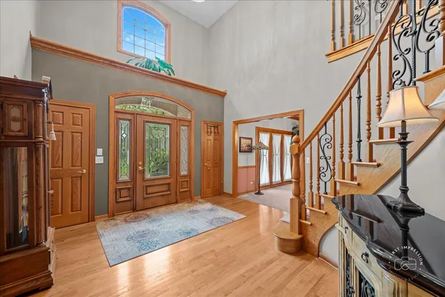 a view of an entryway with wooden floor and livingroom