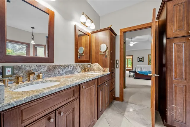 a spacious bathroom with a granite countertop sink and a mirror