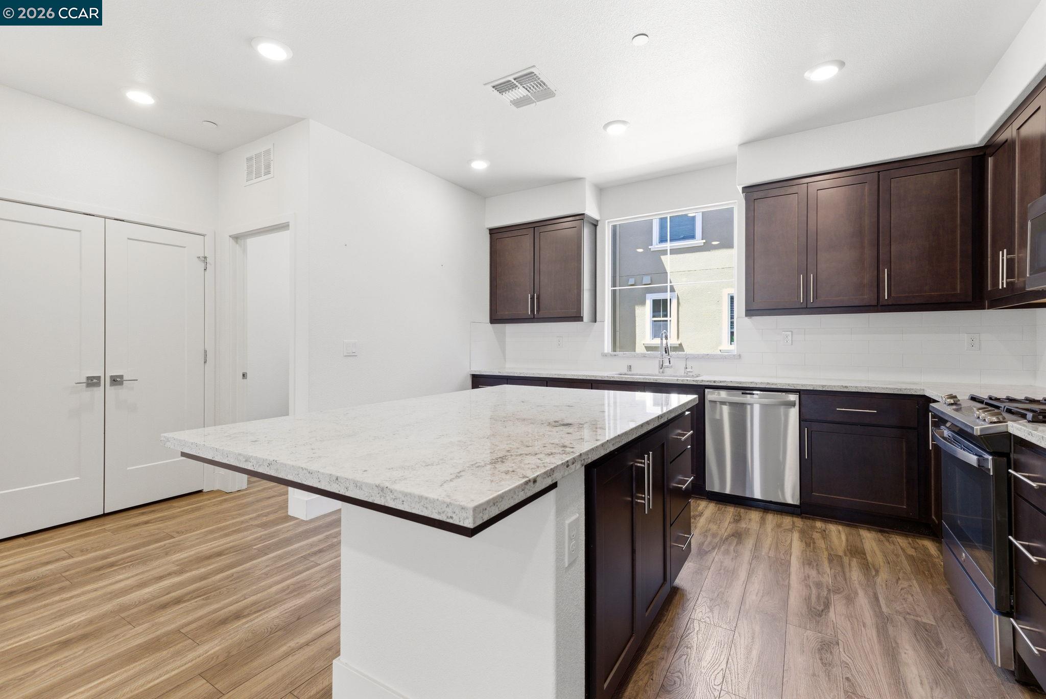 205 Plum Tree Street Livermore, CA 94551 - Photo 20 of 47 a kitchen with stainless steel appliances granite countertop a kitchen island a stove and a sink