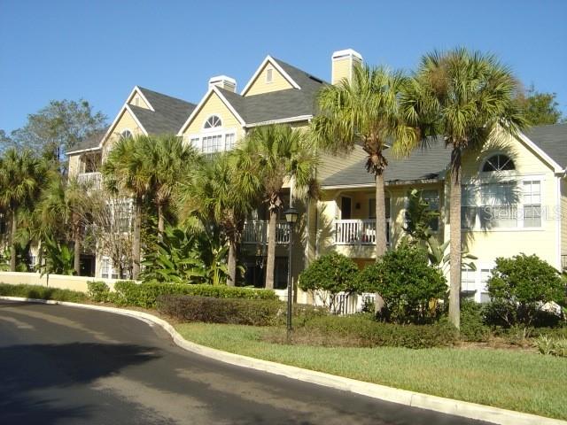 a front view of a house with a yard and potted plants