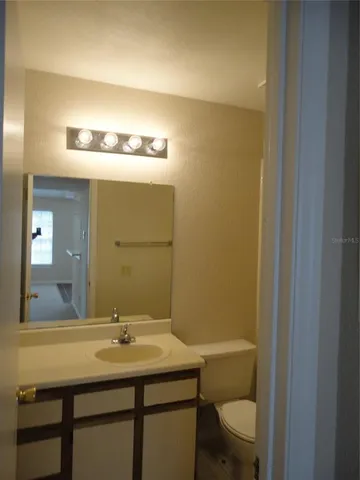 a bathroom with a sink mirror and toilet