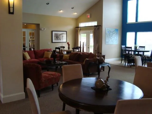 a view of a patio with chairs and tables and plants