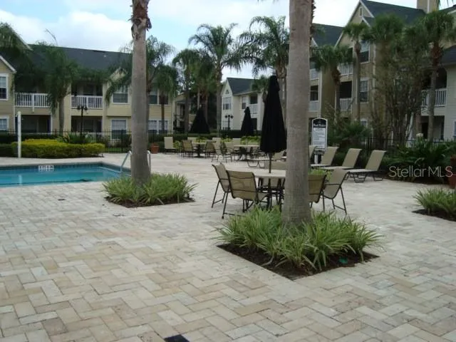 a view of a house with backyard patio and swimming pool