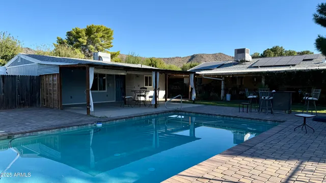 a view of a patio with table and chairs with wooden floor and fence