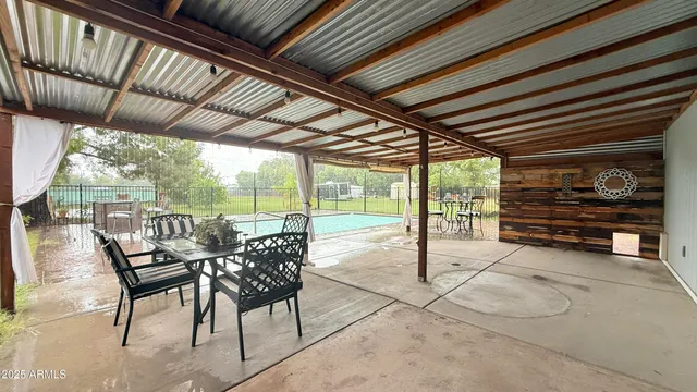 a view of a porch with furniture and wooden deck