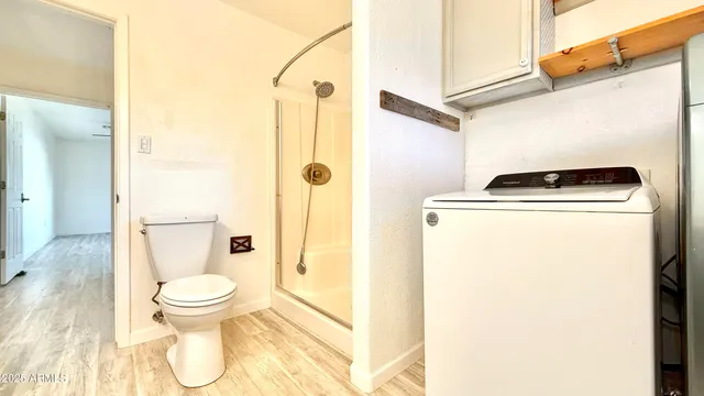 a bathroom with a toilet and a shower