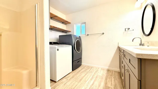 a bathroom with a sink a mirror and shower