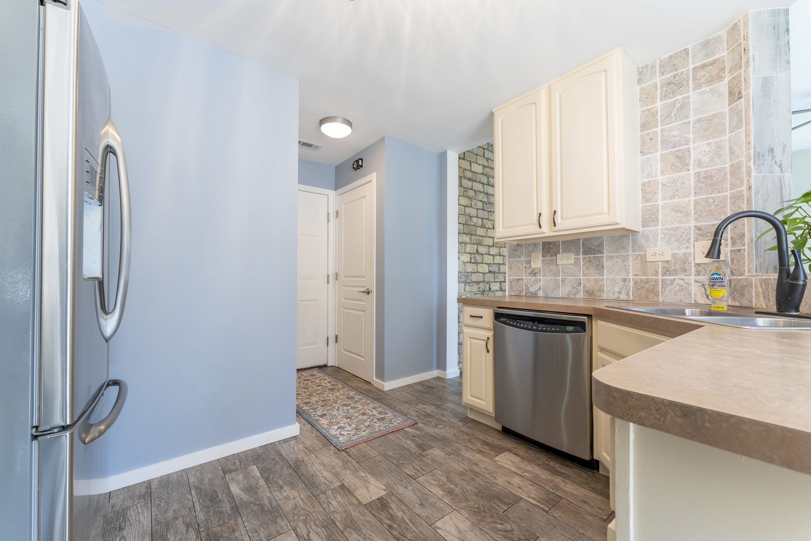 794 Pointe Drive, Unit 794 Crystal Lake, IL 60014 - Photo 7 of 20 a kitchen with granite countertop a refrigerator and a sink