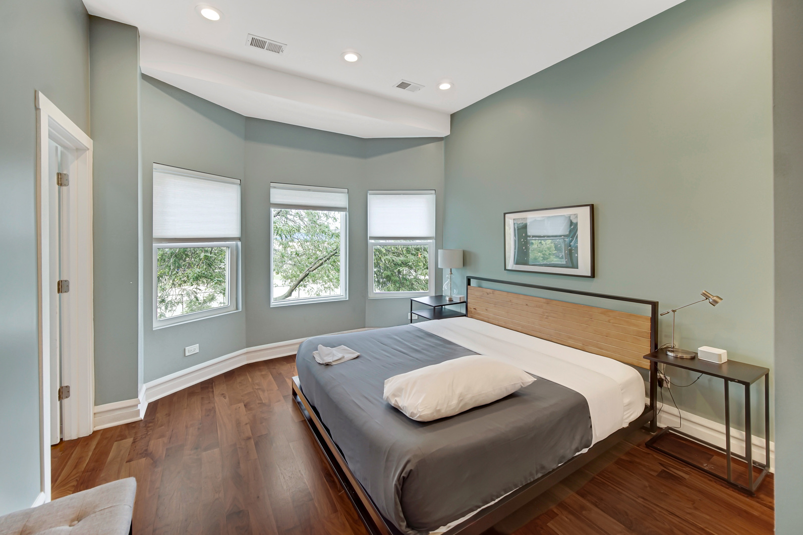 2123 West Adams Street Chicago, IL 60612 - Photo 17 of 29 a bedroom with a large bed and a window