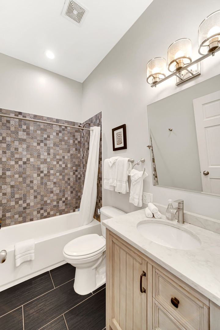 2123 West Adams Street Chicago, IL 60612 - Photo 22 of 29 a bathroom with a sink a toilet and shower