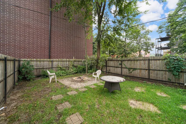a view of a backyard with a patio and a garden