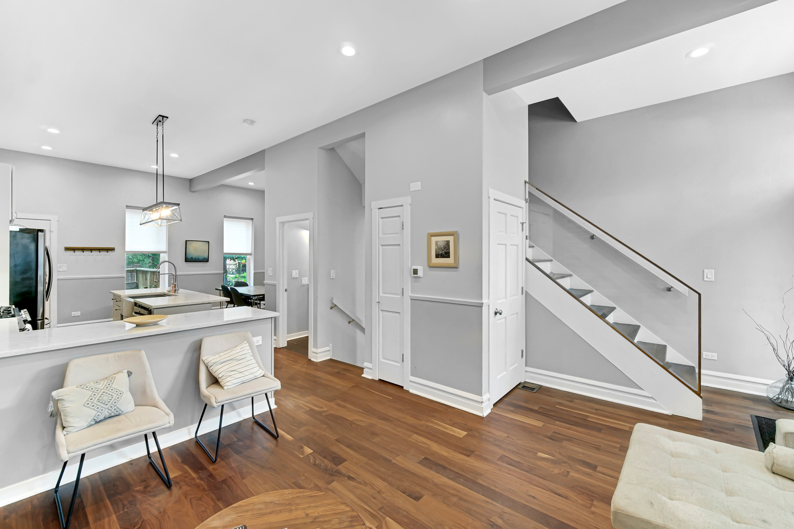 2123 West Adams Street Chicago, IL 60612 - Photo 4 of 29 a large white kitchen with wooden floor and furniture