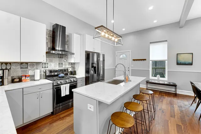 a kitchen with granite countertop a sink appliances and cabinets