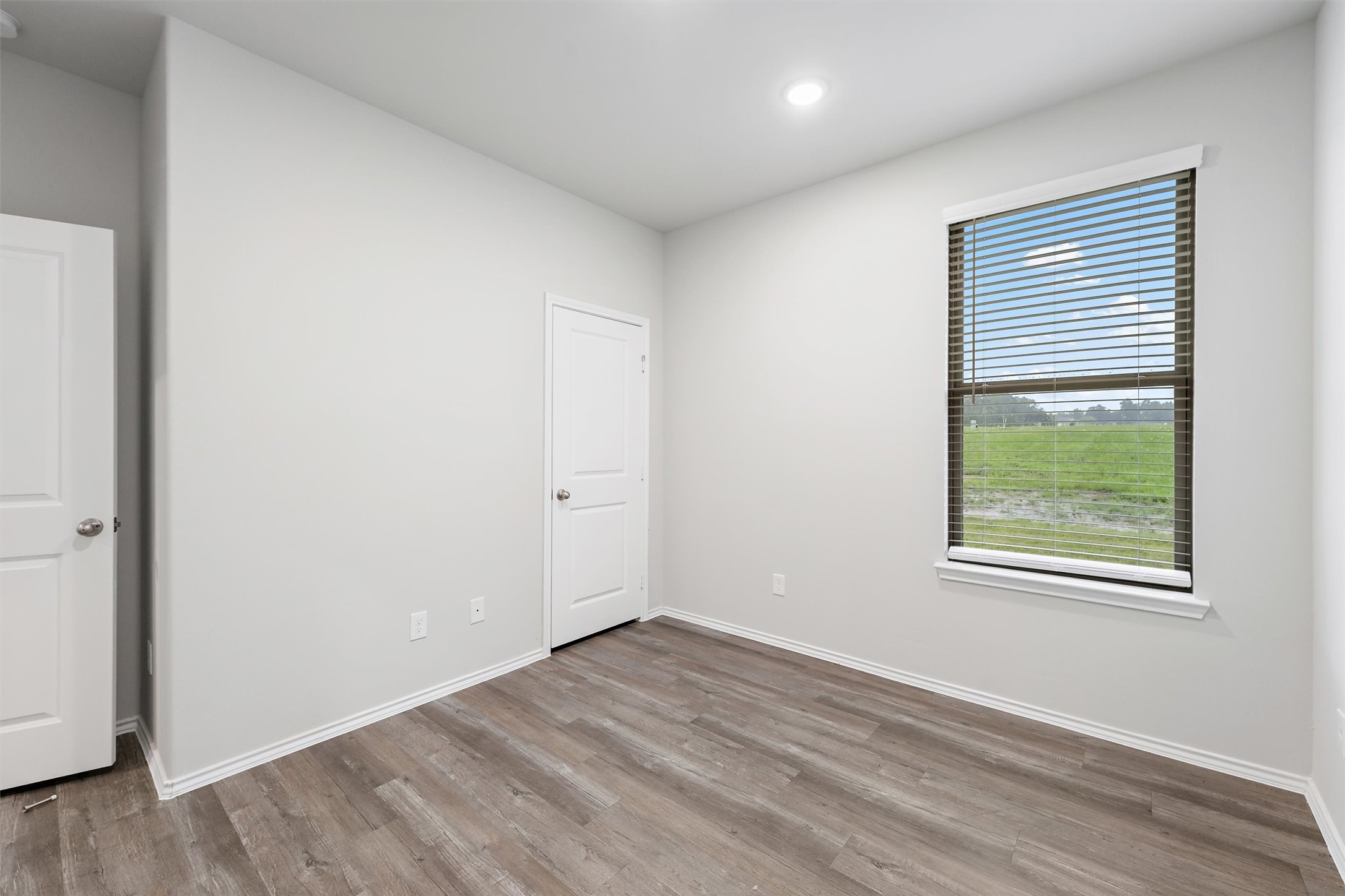 369 Byrd Drive Lufkin, TX 75901 - Photo 21 of 29 an empty room with wooden floor and windows