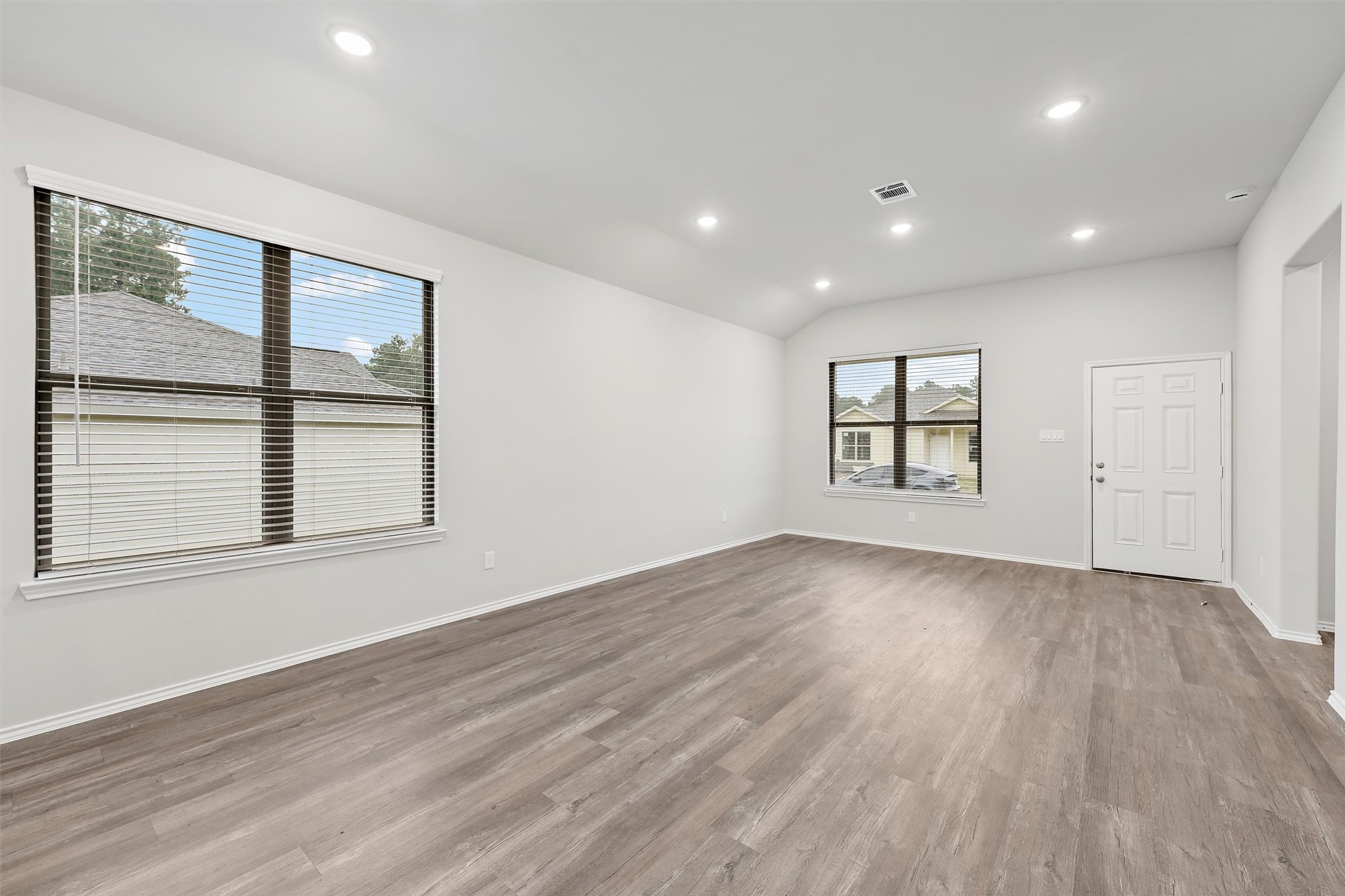 369 Byrd Drive Lufkin, TX 75901 - Photo 6 of 29 a view of an empty room with a window and wooden floor