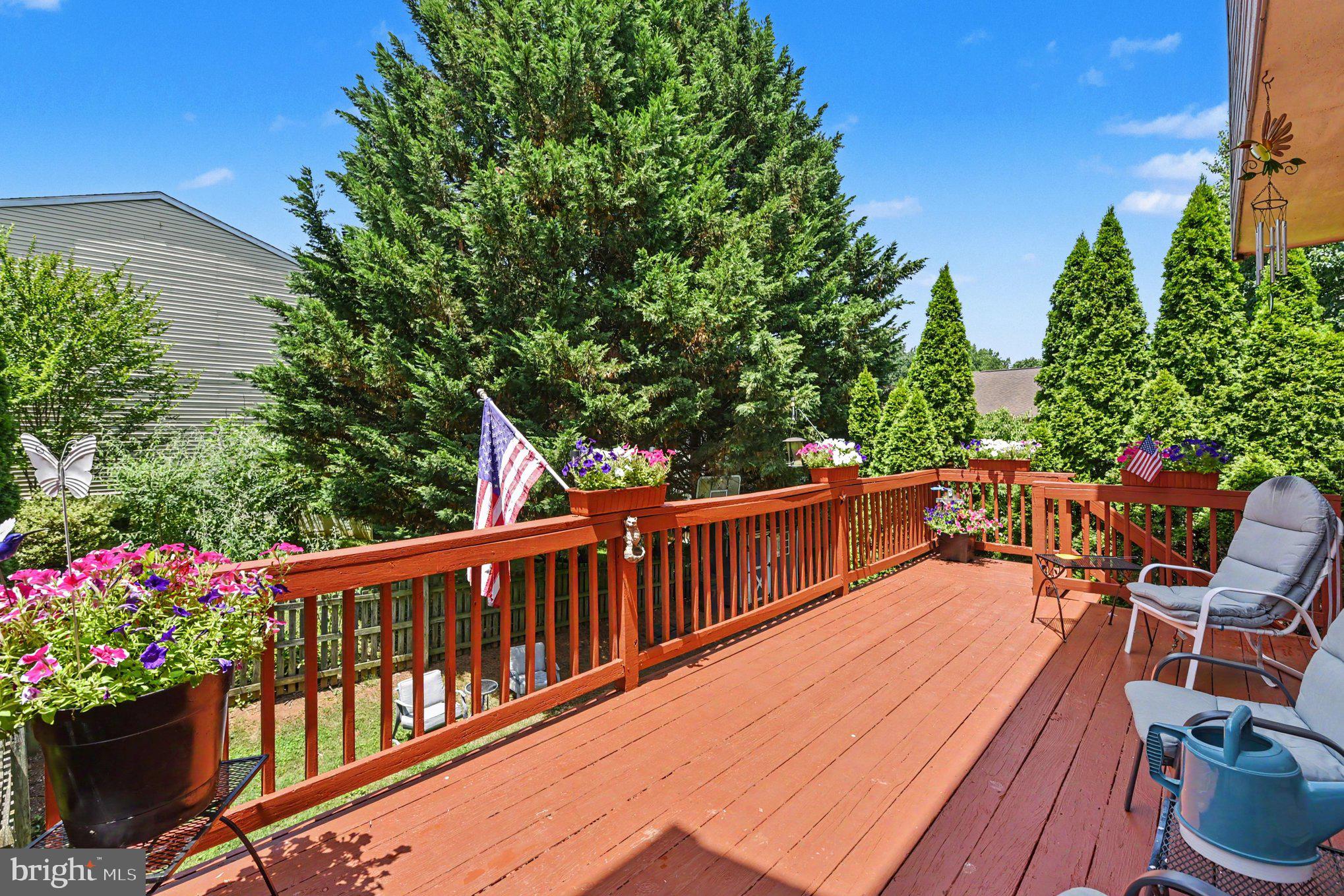 72 Powder View Court Nottingham, MD 21236 - Photo 12 of 26 Sunny deck adorned with vibrant blooms.