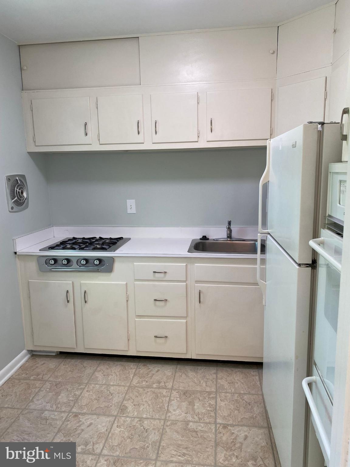 312 East Melrose Avenue Baltimore, MD 21212 - Photo 3 of 6 a kitchen with granite countertop cabinets and white appliances