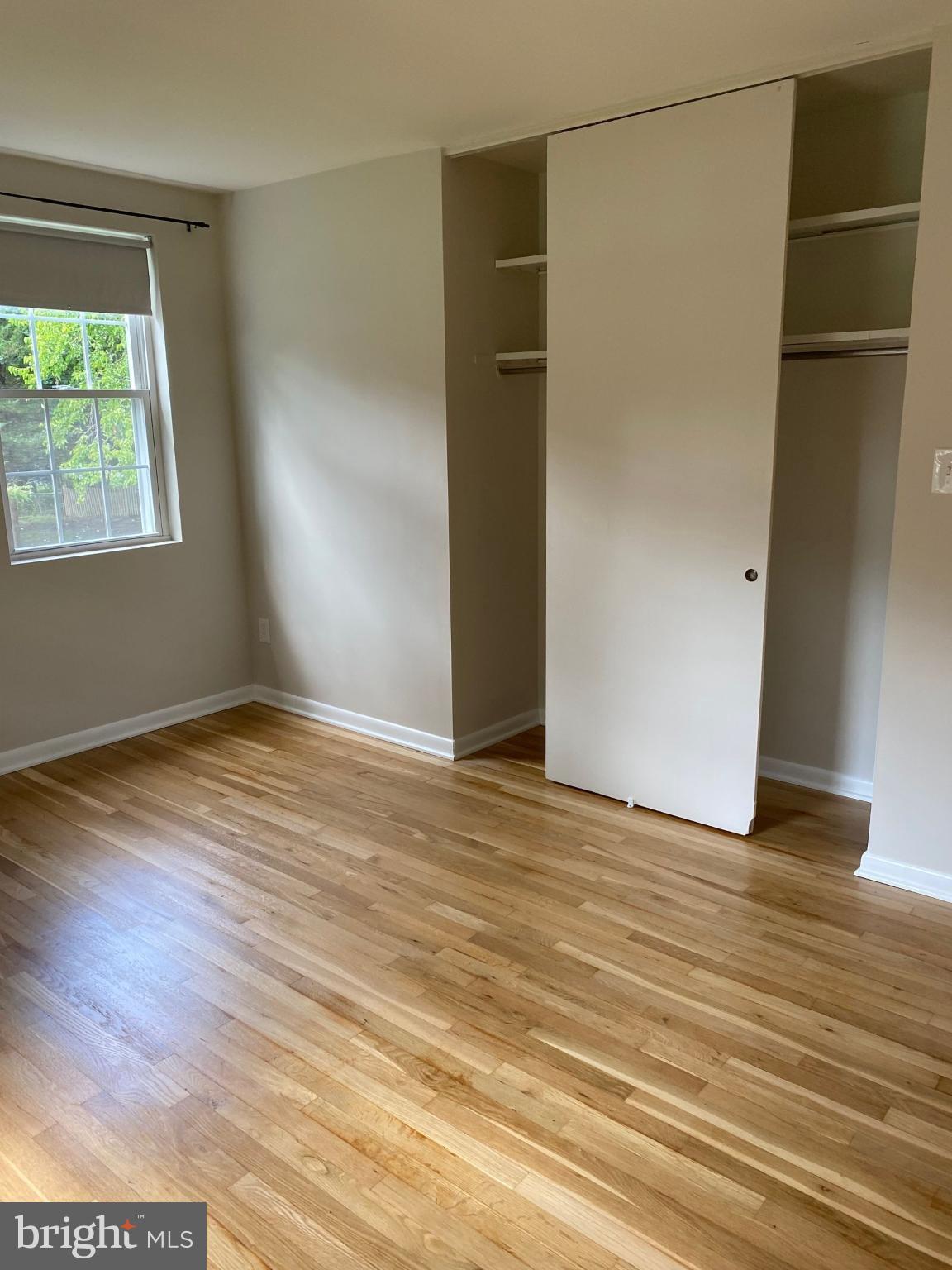 312 East Melrose Avenue Baltimore, MD 21212 - Photo 5 of 6 an empty room with wooden floor and windows