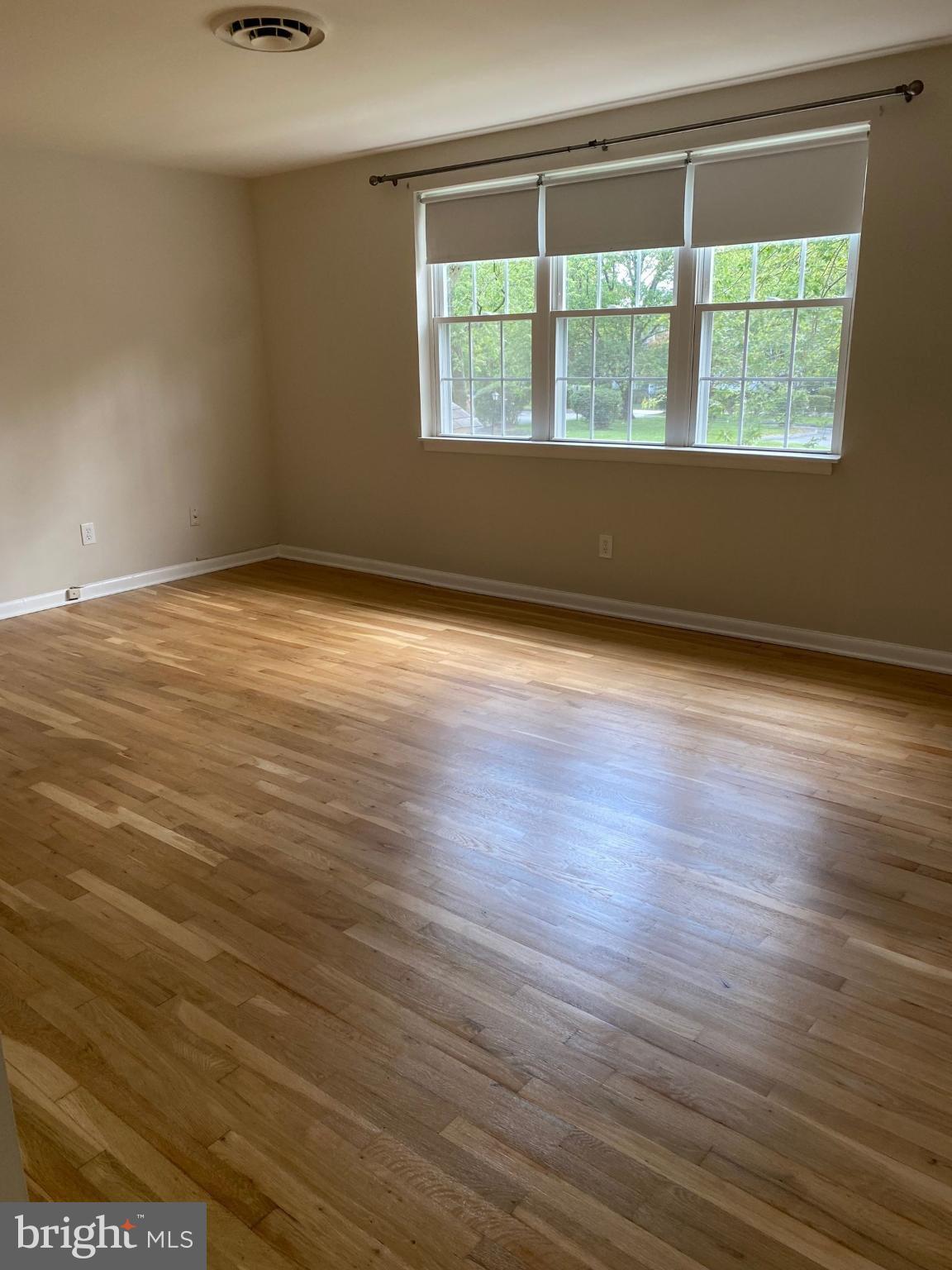 312 East Melrose Avenue Baltimore, MD 21212 - Photo 6 of 6 an empty room with wooden floor and windows