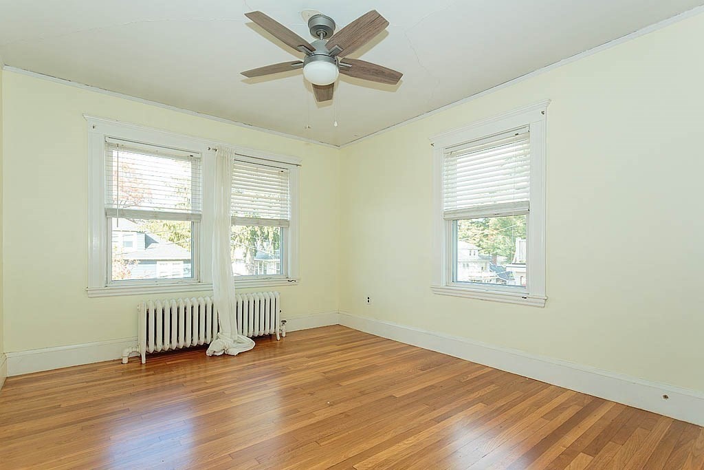 15 Fairfax Road Milton, MA 02186 - Photo 21 of 37 a view of an empty room with wooden floor and a window