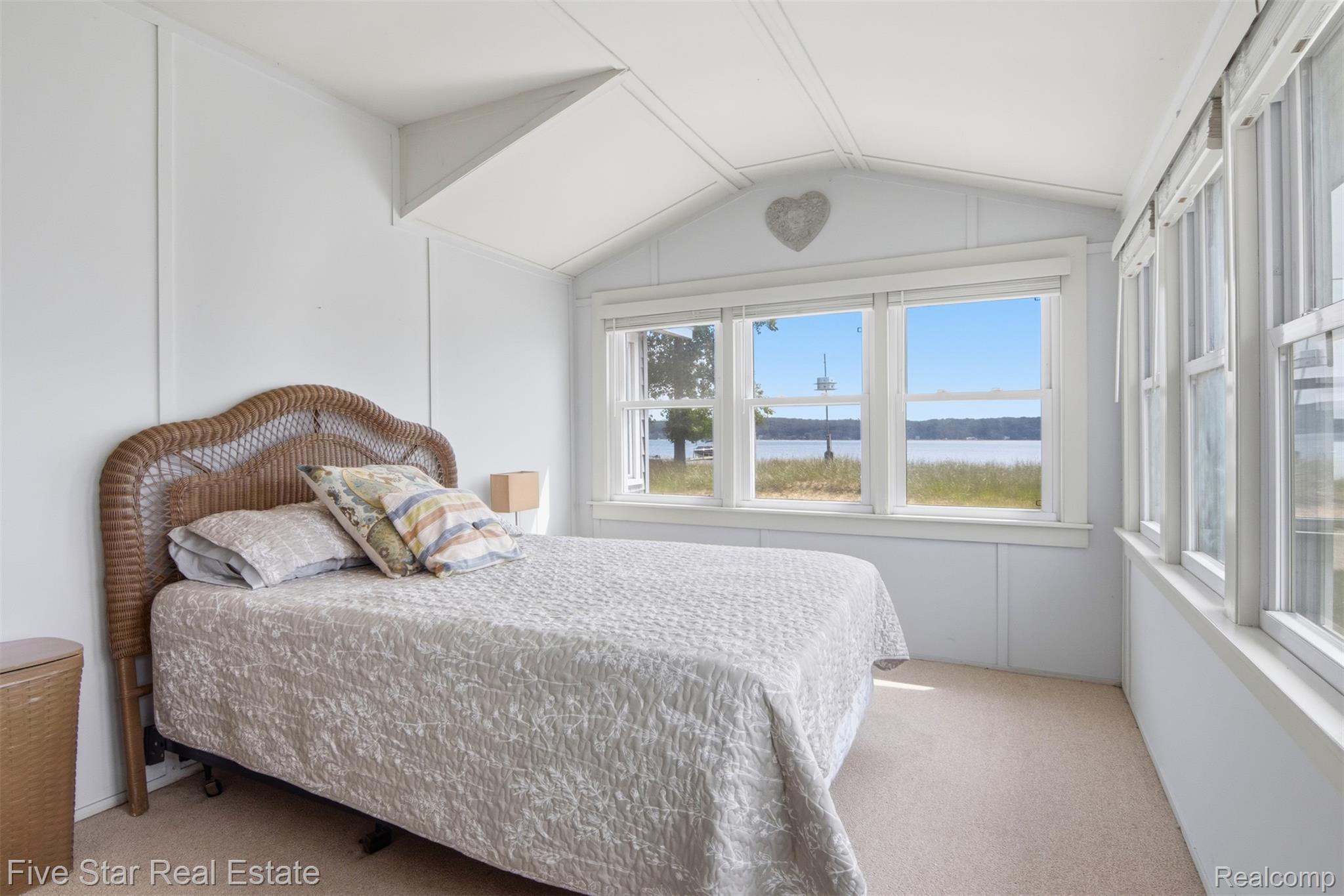 2588 Lakeview Road Onekama, MI 49675 - Photo 20 of 32 Room with multiple windows, offering expansive water scenery