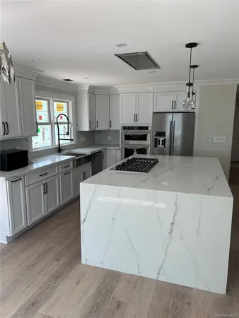 a kitchen with a stove a sink and a refrigerator