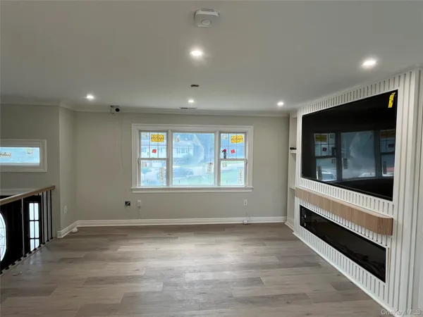 a view of room with window and wooden floor