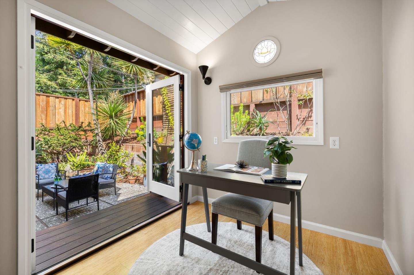 a room with patio furniture and a potted plant