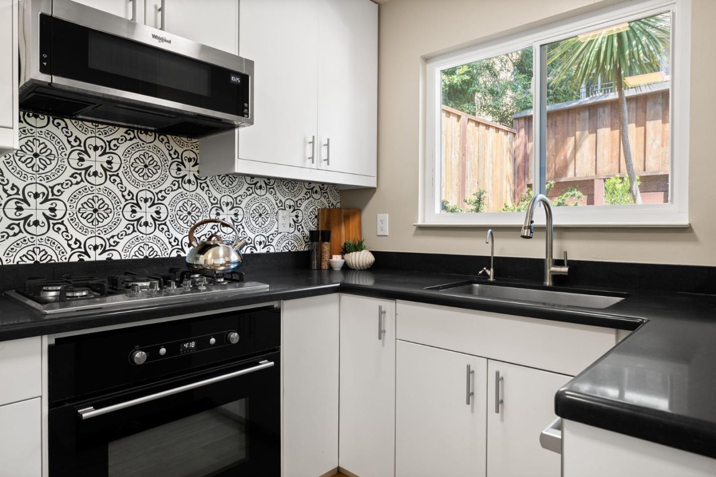 1337 Henry Street, Unit E Berkeley, CA 94709 - Photo 11 of 33 a kitchen with a sink a stove and a microwave