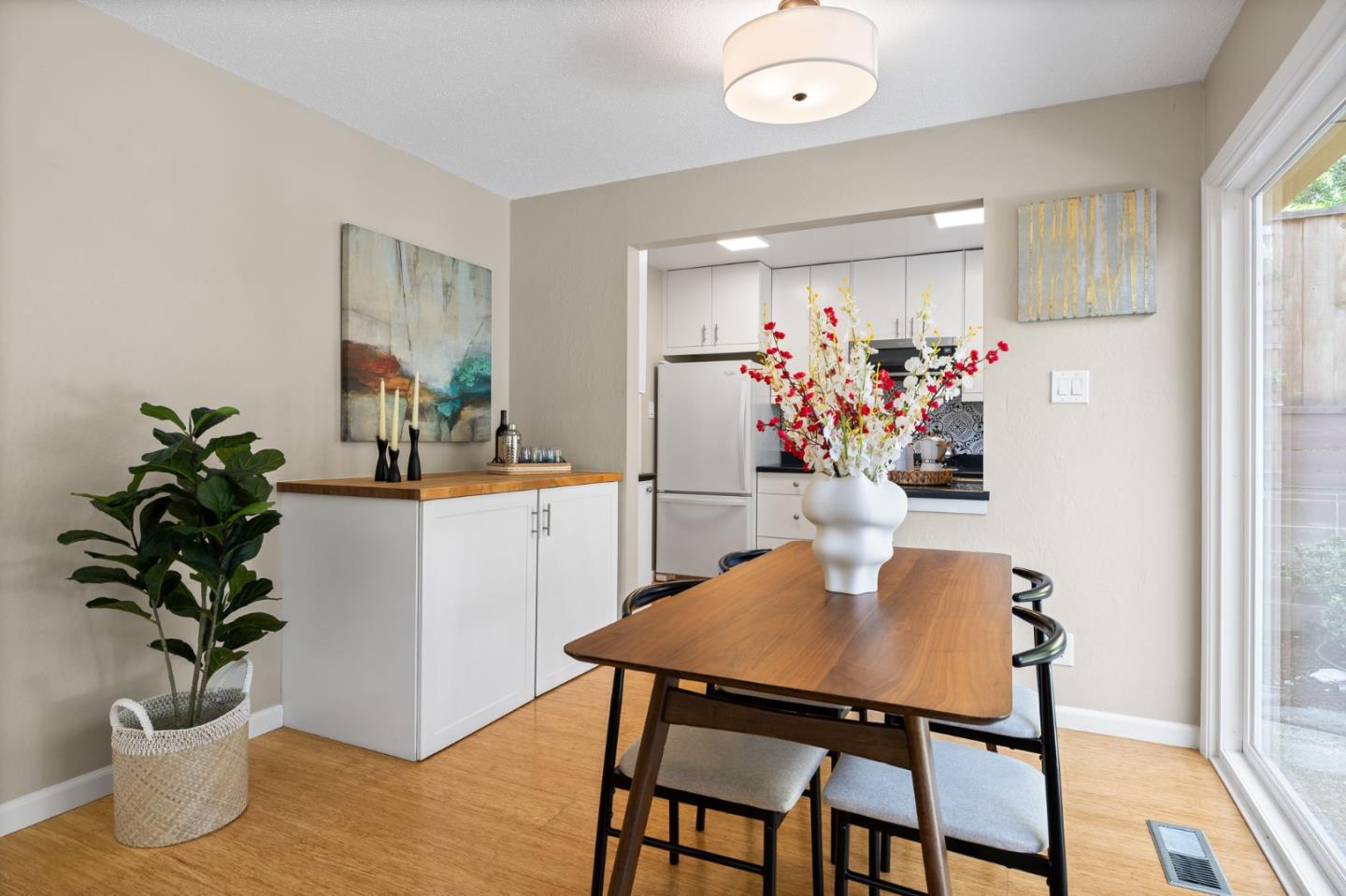 1337 Henry Street, Unit E Berkeley, CA 94709 - Photo 13 of 33 a dining room with furniture potted plants and wooden floor