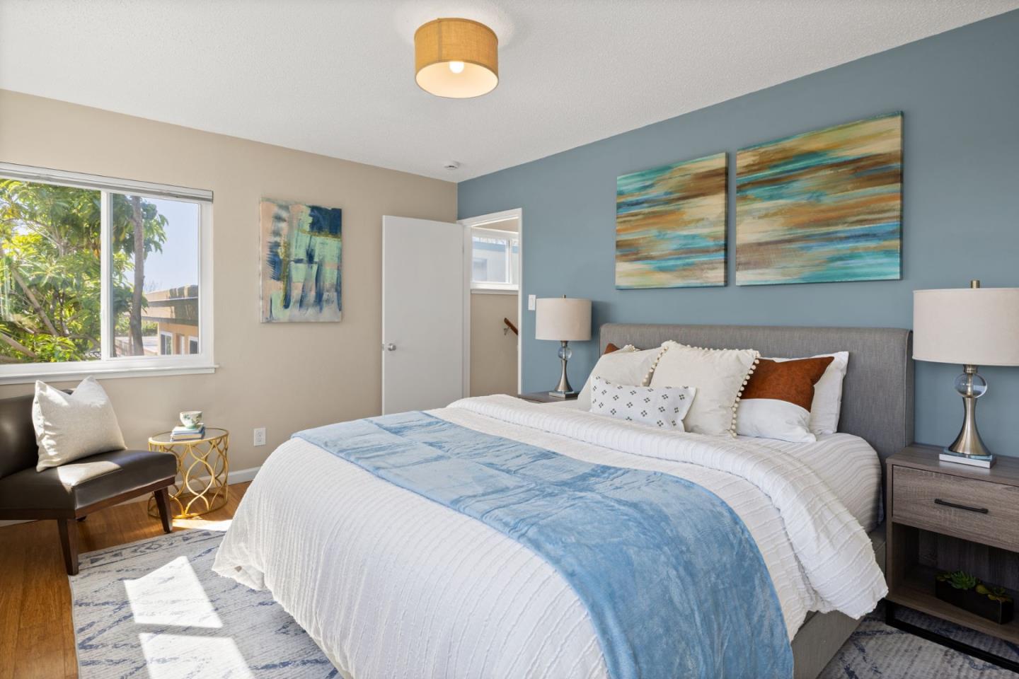 1337 Henry Street, Unit E Berkeley, CA 94709 - Photo 14 of 33 a bedroom with a bed and wooden floor